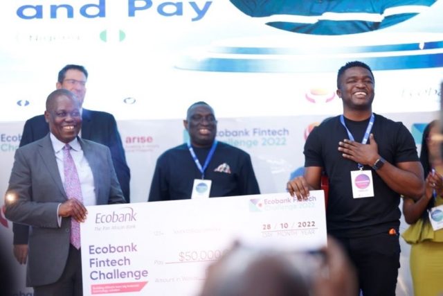 Ecobank Group CEO Ade Ayeyemi (Left) hands over a cash prize of USD50,000 to Touch and Pay CEO, Michael Oluwole.