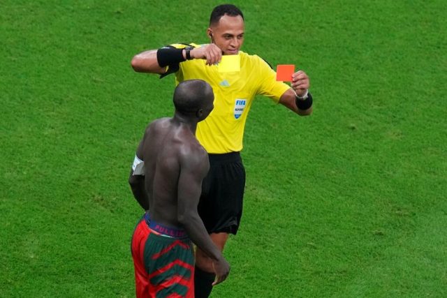 Moroccan American Referee, Ismail Elfath shows Cameroon's captain Vincent Aboubakar's the red card for taking his shirts off after his stunning header earned them victory against Brazil