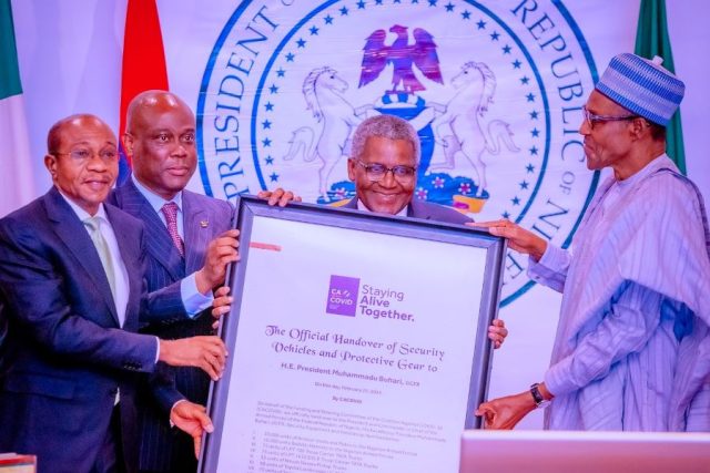 CBN Governor, Aliko Dangote of CACOVID presenting security equipment to the FG
