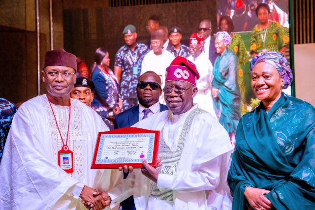 INEC Chairman presenting Certificate of Return to Bola Ahmed Tinubu winner of the 2023 Nigeria Presidential election