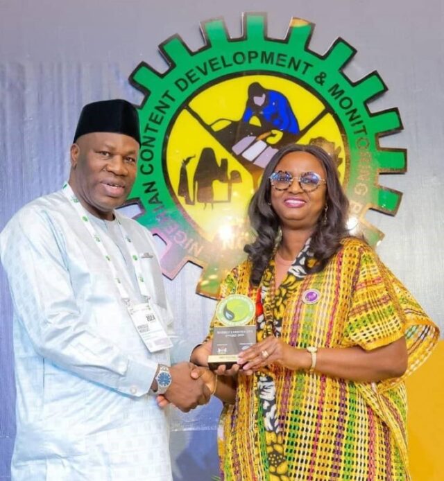 Nicholas Agbo Ella presenting the Award to SNEPCo's Elohor Aiboni