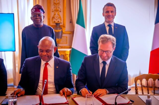 Chairman of UBA Group in the presence of President Tinubu and the President of France, Emmanuel Macron, sign a business cooperation agreement with the French Finance Minister, Antoine Armand