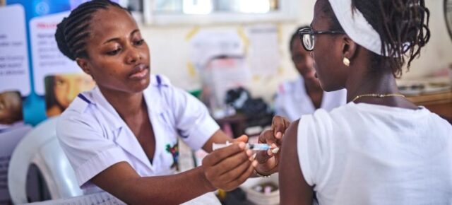 A health worker immunizes a girl with the HPV vaccine in Lagos, Nigeria