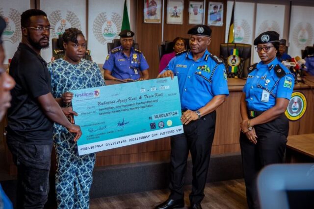 A family member of fallen hero receives her cheque from the IGP on behalf of the family