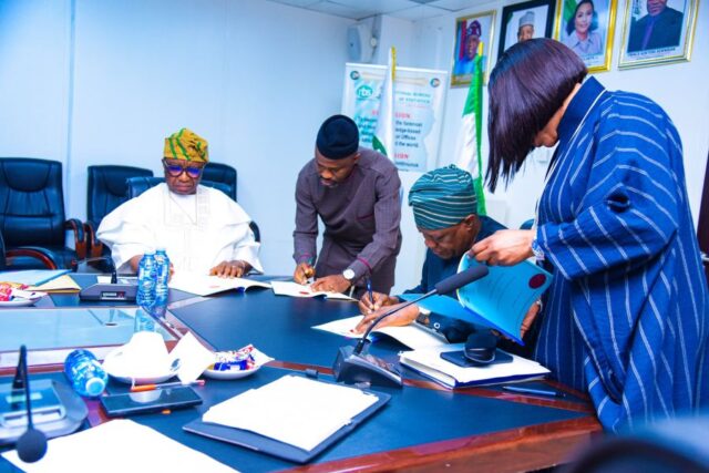 NBS CEO Prince Adeyemi Adeniran sign the dotted line with Data Protection Commission boss, Dr. Vincent Olatunji