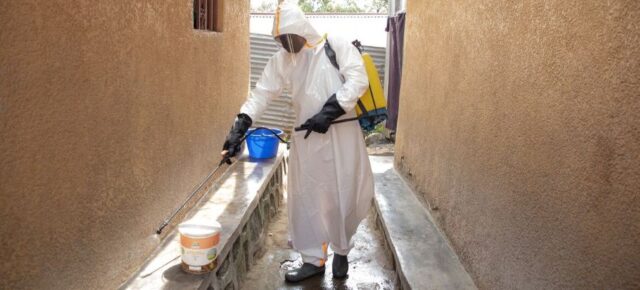 The home of a person with a confirmed Ebola case is disinfected in Brazza village
