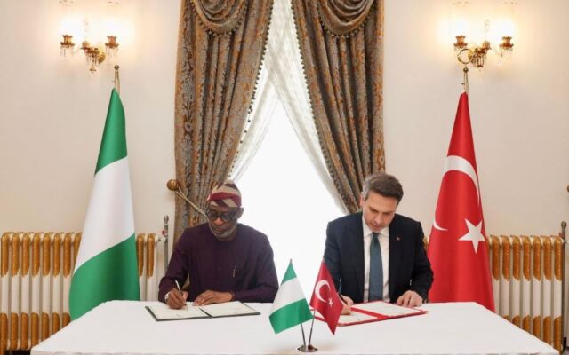 Minister of Solid Minerals, Dele Aleke (r) signing the MoU with a Turkish official
